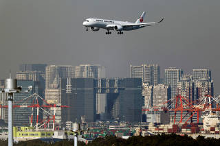 An airplane of Japan Airlines (JAL) approaches to land at Haneda International Airport in Tokyo
