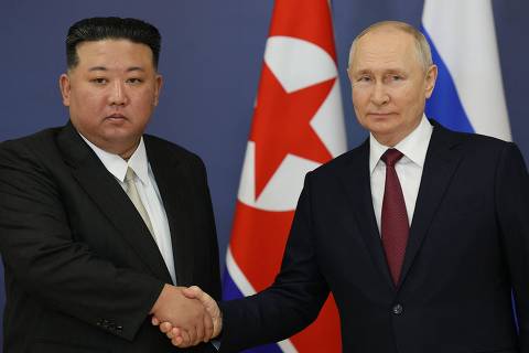 TOPSHOT - This pool image distributed by Sputnik agency shows Russian President Vladimir Putin (R) and North Korea's leader Kim Jong Un (L) shaking hands during their meeting at the Vostochny Cosmodrome in Amur region on September 13, 2023, ahead of planned talks that could lead to a weapons deal with Russian President. (Photo by Vladimir SMIRNOV / POOL / AFP) ORG XMIT: 9a54029a11f2d733