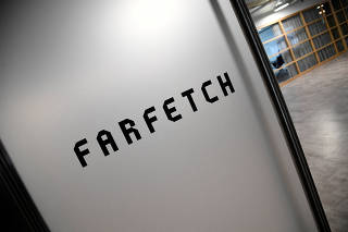 FILE PHOTO: Branding for online fashion house Farfetch is seen at the company headquarters in London