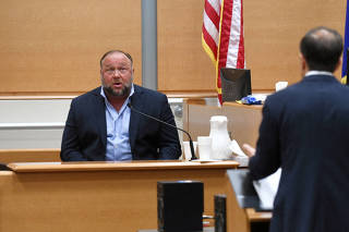 FILE PHOTO: Infowars founder Alex Jones takes the witness stand to testify