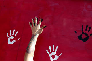 FILE PHOTO: A man places his hand on a mural to honor earthquake victims in Mexico City