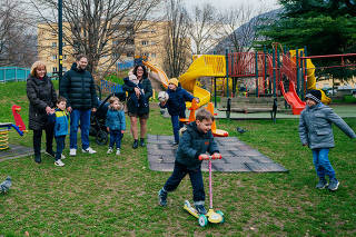The Baldo family in the park in front of their apartment in Bolzano, Italy, on March 8, 2024. (Davide Monteleone/The New York Times)