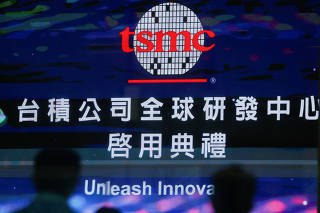 FILE PHOTO: People attend the opening of TSMC global R&D center in Hsinchu