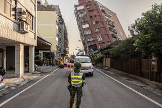 Search and rescue personnel prepare to enter a leaning building following a magnitude-7.4 earthquake in Hualien, Taiwan, on Wednesday, April 3, 2024. (Lam Yik Fei/The New York Times)