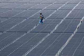 A worker walks at Brazil?s biggest floating solar plant with 10,500 plates on the water surface at the Billings dam developed by Empresa Metropolitana de Aguas e Energia in Sao Paulo