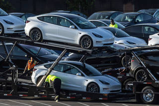 FILE PHOTO: Tesla Model 3 vehicles are seen for sale at a Tesla facility in Fremont, California