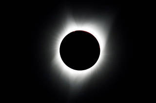 FILE PHOTO: A total solar eclipse is photographed from atop Carroll Rim Trail at Painted Hills near Mitchell, Oregon