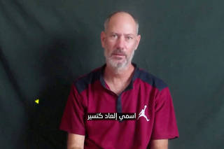 Elad Katzir, 47, who was taken hostage on October 7 during the deadly attack by the Palestinian Islamist group Hamas, speaks in an unknown location in this screengrab taken from a handout video