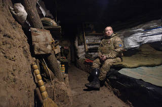 Odin, a commander in the 28th Separate Mechanized Brigade who lost his lower leg stands in a dugout, in Donetsk
