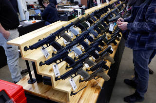 FILE PHOTO: Customers shop at the Des Moines Fairgrounds Gun Show at the Iowa State Fairgrounds in Des Moines, Iowa