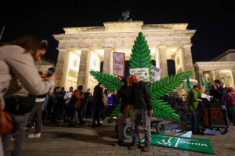 People pose for a picture as Germany's friends of cannabis celebrate the part legalisation of cannabis starting on April 1 with a 