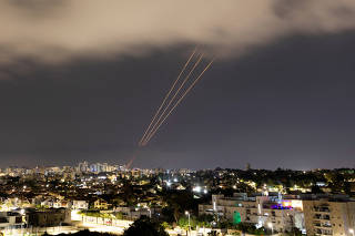 FILE PHOTO: An anti-missile system operates after Iran launched drones and missiles towards Israel, as seen from Ashkelon