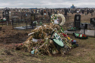The grave of Anna Haidarzhy and her 4-month-old son, Tymofii, who were killed in a Russian drone attack on an apartment block in Odesa, Ukraine, March 19, 2024. (Oksana Parafeniuk/The New York Times)