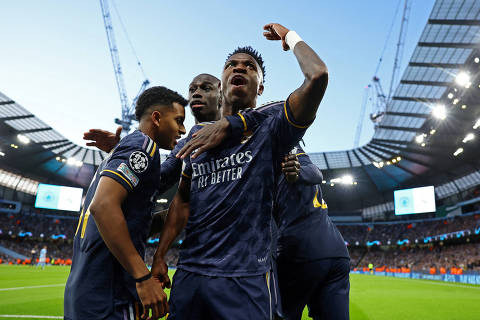 Soccer Football - Champions League - Quarter Final - Second Leg - Manchester City v Real Madrid - Etihad Stadium, Manchester, Britain - April 17, 2024 Real Madrid's Rodrygo celebrates scoring their first goal with Vinicius Junior and teammates REUTERS/Molly Darlington     TPX IMAGES OF THE DAY