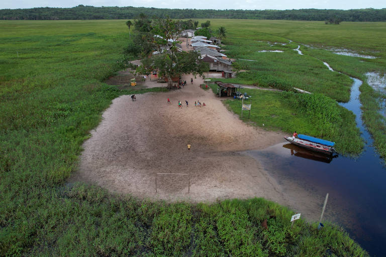 Vista aérea de aldeia indígena perto de um riacho