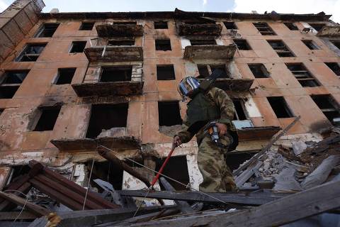 A Russian sapper checks a ruined building in Mariupol, in Russian-controlled Ukraine, on April 19, 2024 amid the Russia-Ukraine conflict. (Photo by AFP)