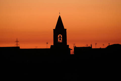 FILE PHOTO: FILE PHOTO: The bell tower of a church is seen during sunset in the village of Montmaneu, north of Barcelona, Spain, January 28, 2022. REUTERS/Nacho Doce/File Photo/File Photo ORG XMIT: FW1