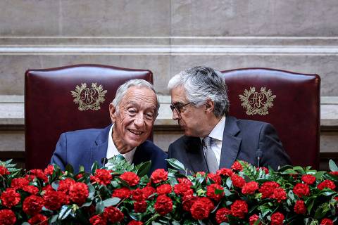 Portuguese President Marcelo Rebelo de Sousa (L) and Portuguese Parliament's President Jose Pedro Aguiar Branco talk during the solemn session at the Portuguese Parliament in Lisbon on April 25, 2024, on the 50th anniversary of the Carnation Revolution. Portugal marks the 50th anniversary of the Carnation Revolution, a military coup that put an end to Europe's longest-lived dictatorship and 13 years of colonial wars in Africa. (Photo by FILIPE AMORIM / AFP)