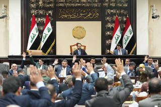FILE PHOTO: Iraqi lawmakers attend a parliamentary session to vote on the federal budget at the parliament headquarters in Baghdad