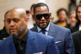 FILE PHOTO: Grammy-winning R&B singer R. Kelly arrives for a child support hearing in Chicago