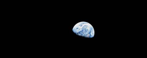 24 Dec. 1968-- The rising Earth is about five degrees above the lunar horizon in this telephoto view taken from the Apollo 8 spacecraft near 110 degrees east longitude. The horizon, about 570 km from the spacecraft, is near the eastern limb of the moon as viewed from Earth. Width of the view at the horizon is about 150 km .The crew took the photo around 10:40 a.m. Houston time on Dec. 24