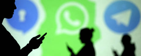 FILE PHOTO: Silhouettes of mobile users are seen next to logos of social media apps Signal, Whatsapp and Telegram projected on a screen in this picture illustration taken March 28, 2018.  REUTERS/Dado Ruvic/Illustration/File Photo ORG XMIT: FW1