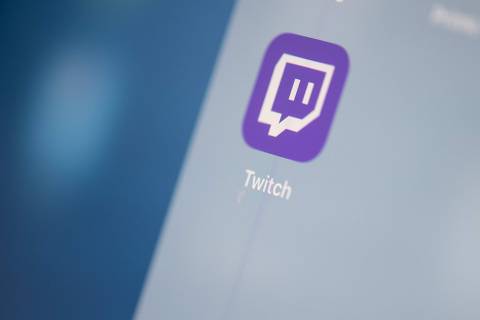 (FILES) This illustration picture taken on July 24, 2019 in Paris shows the US live streaming video platform Twitch logo application on the screen of a tablet. US-based live gaming streaming platform Twitch said on December 6, 2023 that it would stop its service in South Korea in February because of 