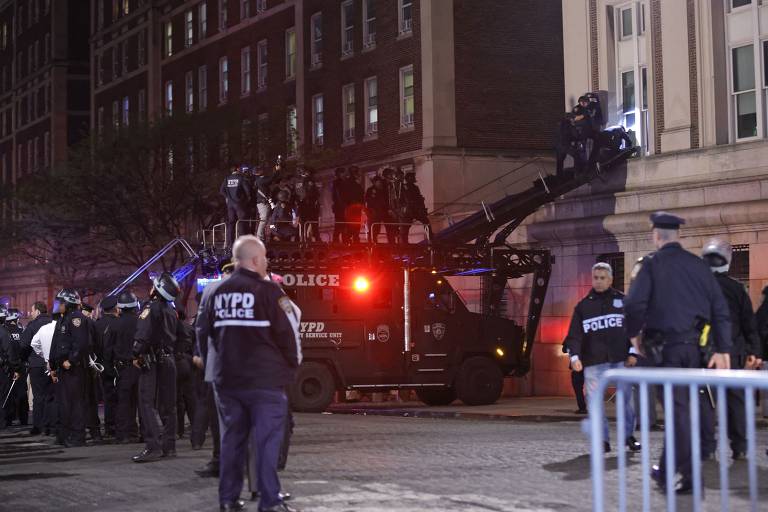 Agentes da tropa de choque do Departamento de Polícia de Nova York entram em prédio invadido por manifestantes pró-Palestina da Universidade Columbia