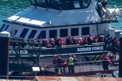 People believed to be migrants, disembark from a British Border Force vessel as they arrive at the Port of Dover in Dover, Britain, April, 29, 2024. REUTERS/Chris J. Ratcliffe ORG XMIT: PPP-CJR103