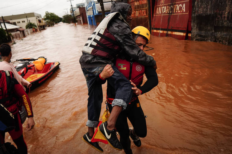 Defesa civil e voluntários ajudam na remoção da população das áreas afetadas pelo alagamento