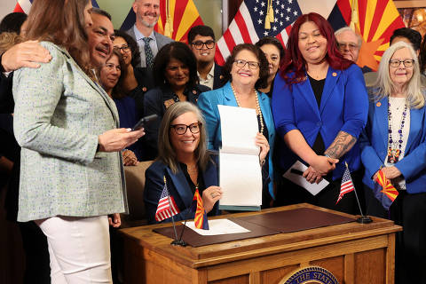 Arizona Gov. Katie Hobbs holds up the signed bill HB2677, the 1864 abortion ban repeal law, in Phoenix, Arizona, U.S., May 2, 2024. REUTERS/Liliana Salgado ORG XMIT: MEX