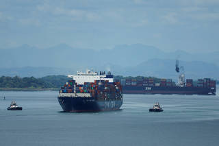 Cargo vessels transit through the Panama Canal, in Colon