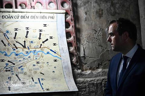 French Defence Minister Sebastien Lecornu looks at a Dien Bien Phu battle's map as he visits the command bunker of France's General Christian de Castries in Dien Bien Phu city on May 6, 2024. Fully packed with army men and women, ethnic minorities and French veterans, Vietnam's Dien Bien Phu city on May 7, marks the 70th anniversary of 