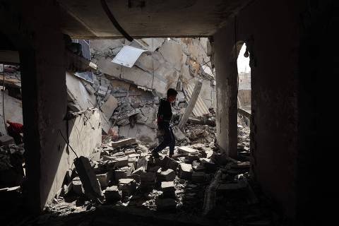 TOPSHOT - A Palestinian boy walks through the rubble following Israeli bombardment of Rafah's Tal al-Sultan district in the southern Gaza Strip on May 7, 2024. The Israeli army said it took 