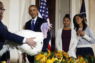 U.S. President Barack Obama is joined by his daughters, Sasha and Malia as they all participate in the annual turkey pardoning ceremony in the White House in Washington