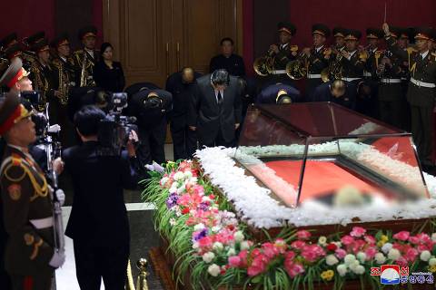 This picture taken and released on May 8, 2024 from North Korea's official Korean Central News Agency (KCNA) via KNS shows North Korea's leader Kim Jong Un (C) and senior officials expressing their condolences to former Workers' Party of Korea Vice Chairman Kim Ki Nam (seen digitally blurred as received from source), who died at the age of 94 on May 7, during a service in Pyongyang. North Korea's former propaganda chief, credited with masterminding the personality cult surrounding the ruling Kim dynasty, has died, state media said on May 8, with leader Kim Jong Un attending his funeral. (Photo by KCNA VIA KNS / AFP) / South Korea OUT / REPUBLIC OF KOREA OUT --  NOTE: Deceased seen digitally blurred as received from source	---EDITORS NOTE--- RESTRICTED TO EDITORIAL USE - MANDATORY CREDIT 