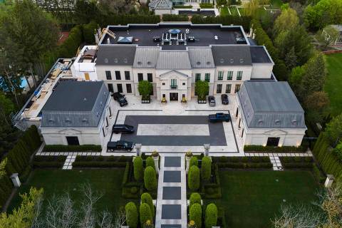 An aerial view shows the home of Canadian rapper Drake in Toronto, Canada, on May 7, 2023. Police in Toronto were investigating a pre-dawn shooting on on May 7 at the sprawling estate of superstar rapper Drake, located in one of Canada's most exclusive neighborhoods. A security guard was standing outside the massive wrought iron gates at the entrance to the rapper's mansion on The Bridle Path road north of downtown Toronto when suspects in a vehicle opened fire, police said. (Photo by Christopher Katsarov Luna / AFP)
