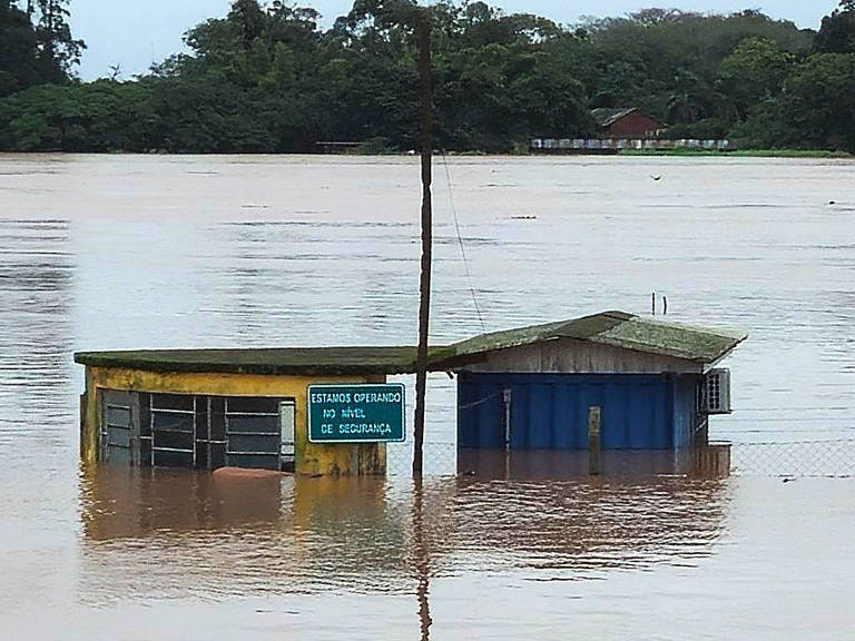Duas casas parcialmente inundadas pelas águas do lago Guaíba, em Porto Alegre