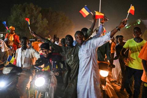 Supporters of Chad's junta chief Mahamat Idriss Deby Itno celebrate their candidate's victory in a street in N'Djamena on May 9, 2024, after the electoral commission said Deby won 61.03 percent of votes, beating his Prime Minister Succes Masra who only garnered 18.53 percent. Soldiers fired shots in the air in Chad's capital N'Djamena out of joy and to deter protesters on May 9, 2024, shortly after junta chief Mahamat Idriss Deby Itno was proclaimed winner of this week's presidential election, AFP journalists reported. (Photo by Issouf SANOGO / AFP)