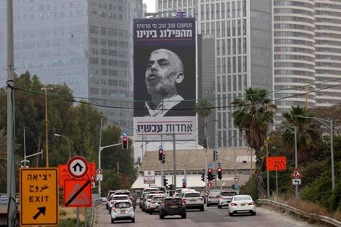 Cars drive past a billboard bearing an inscription in Hebrew which reads 'think well of who benefits from our division - unity now', with a portrait of the head of the political wing of the Palestinian Hamas movement in the Gaza Strip Yahya Sinwar, in Tel Aviv on April 26, 2024, amid the ongoing conflict between Israel and the Palestinian militant group Hamas in the Palestinian territory. (Photo by JACK GUEZ / AFP)