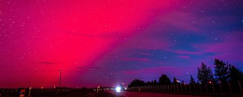 TOPSHOT - The Aurora Australis, also known as the Southern Lights, glow on the horizon over Punta Arenas, Chile, on May 10, 2024. The most powerful solar storm in more than two decades struck Earth, triggering spectacular celestial light shows from Tasmania to Britain -- and threatening possible disruptions to satellites and power grids as it persists into the weekend. (Photo by CLAUDIO MONGE / AFP) ORG XMIT: 2895