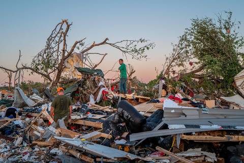 BARNSDALL, OKLAHOMA - MAY 07: The Crowder family surveys their home destroyed by a tornado on May 07, 2024 in Barnsdall, northeast Oklahoma. The EF3 twister that struck claimed one life and destroyed dozens of homes in the community of just over 1,000 people.   Brandon Bell/Getty Images/AFP (Photo by Brandon Bell / GETTY IMAGES NORTH AMERICA / Getty Images via AFP)