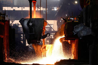 FILE PHOTO: Workers monitor the nickel melting process at a nickel smelter of PT Vale Tbk in Sorowako
