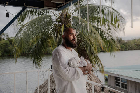 Majid Khan holds his newborn son, Hamza, at a Lebanese-style restaurant in Belize City, Belize, where his family broke their Ramadan fast, on March 24, 2024 (Natalie Keyssar/The New York Times) ORG XMIT: XNYT0517