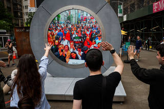 New Yorkers greet people in Dublin during the reveal of The Portal, in New York