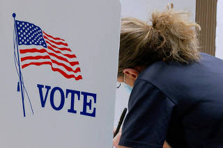 FILE PHOTO: A voter marks a ballot during primary elections at a Wyandotte County polling station