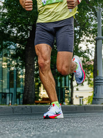 Ekaterinburg, Russia - August 7, 2022: legs male athlete in running shoes Nike run in Europe-Asia Marathon