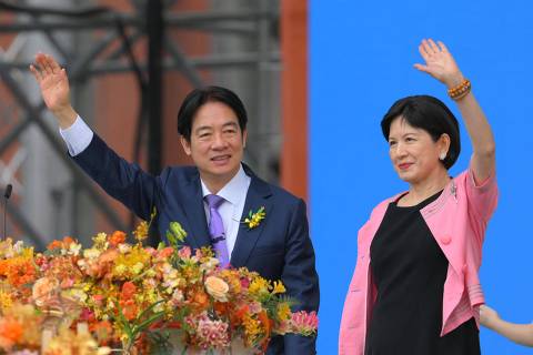 Taiwan's President Lai Ching-te (L) and incoming First Lady Wu Mei-ju (R) wave as he delivers his inaugural speech after being sworn into office during the inauguration ceremony at the Presidential Office Building in Taipei on May 20, 2024. (Photo by Sam YEH / AFP)