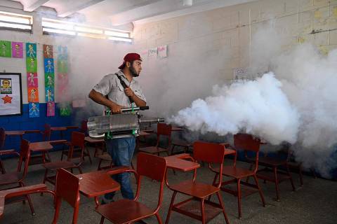 A worker of the Health Ministry sprays insecticides against the Aedes aegypti mosquito inside the Rafael Landivar school in Guatemala City on May 24, 2024. Dengue cases have increased by 473% this year compared to the same period in 2023 in Guatemala, which forced authorities to declare a national emergency, the Health Ministry reported Friday. (Photo by JOHAN ORDONEZ / AFP)