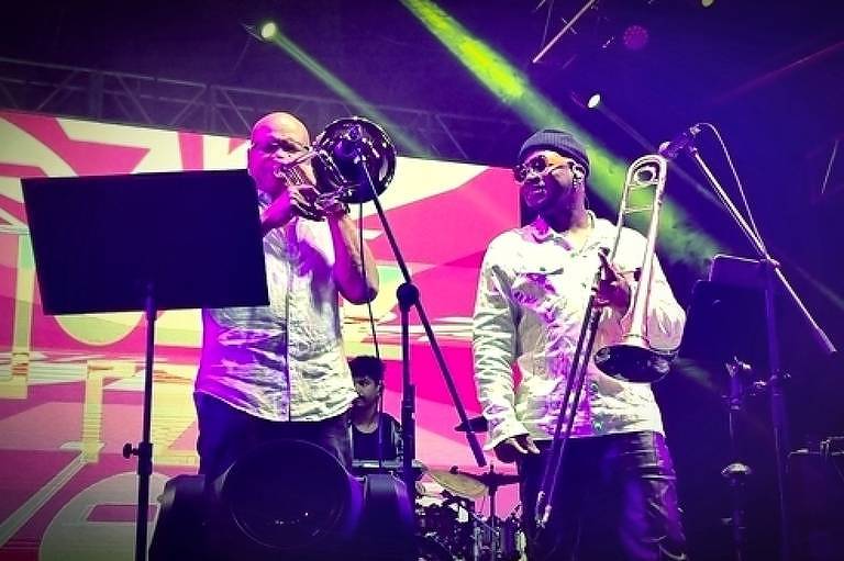Em foto colorida, os trombonistas Robin Eubaks e Joabe Reis aparecem tocando no Bourbon Festival Paraty 
